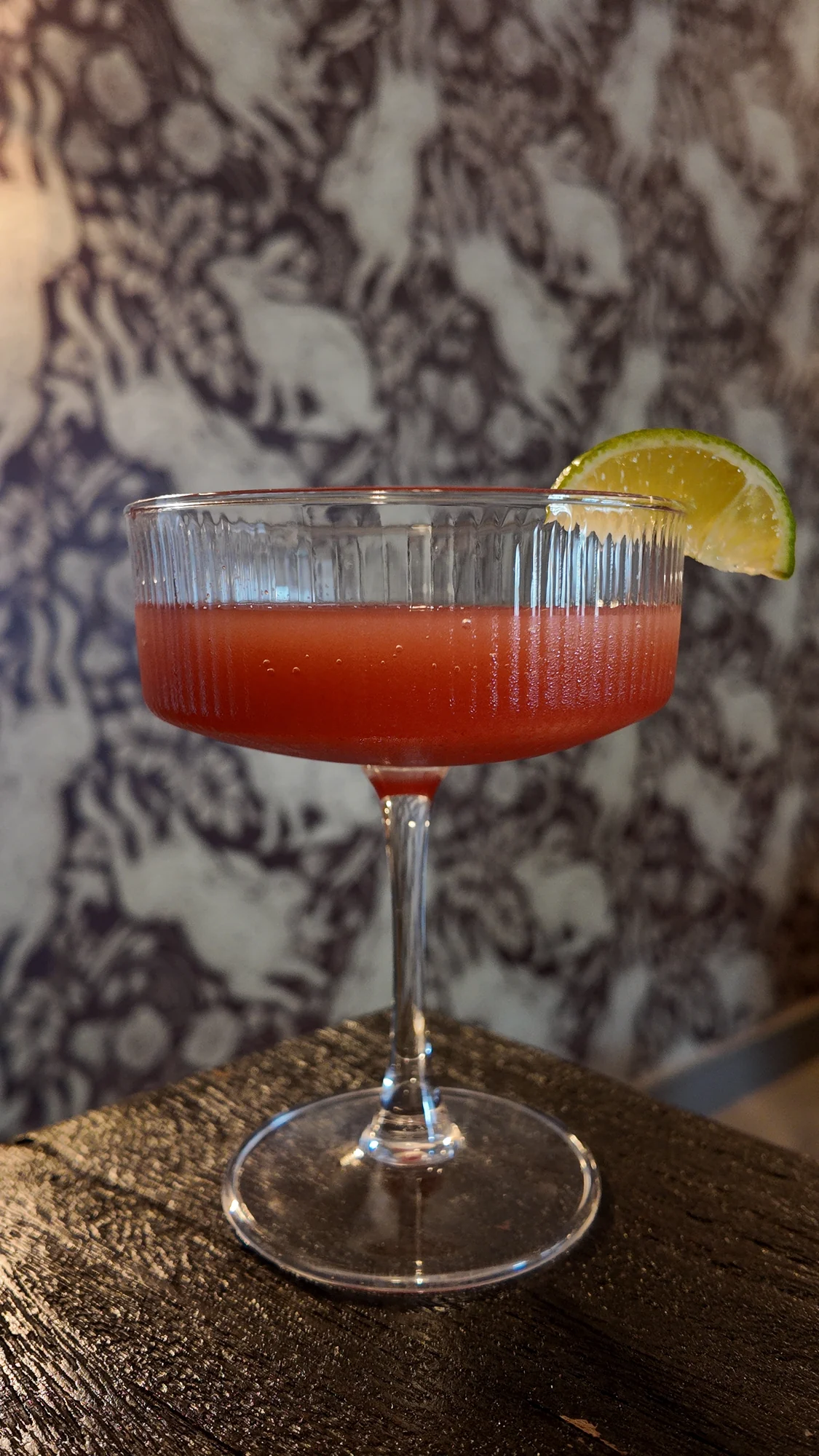 A red cocktail with fresh lime at Black Rabbit