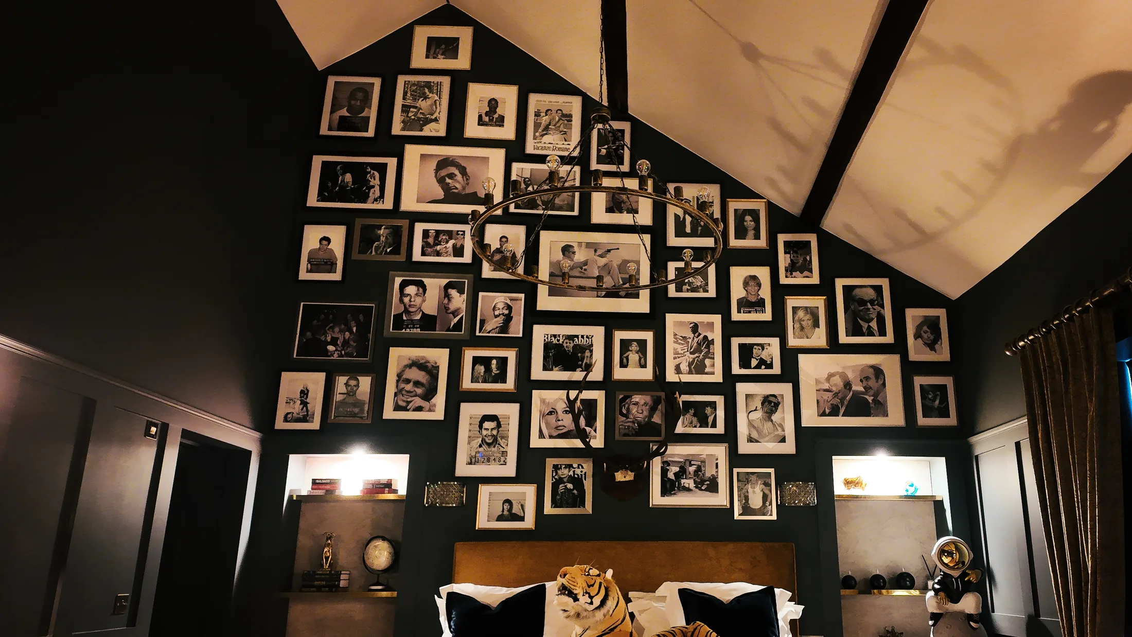Hangover Suite bed beneath a gallery wall